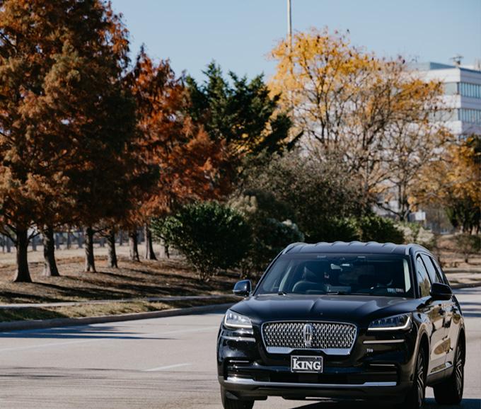 Car driving on a road in the fall