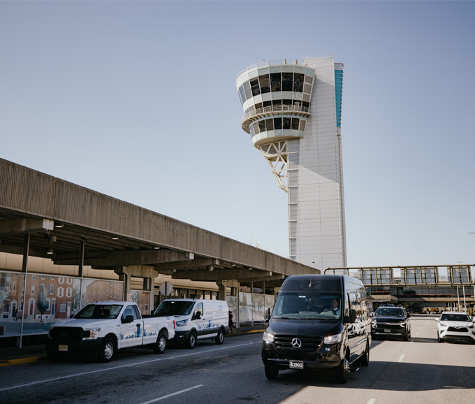 Van driving near airport tower