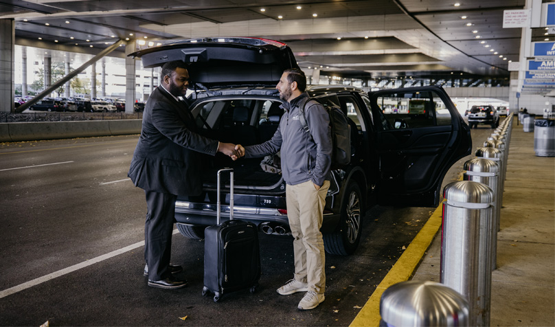 Chauffeur helping customer at airport