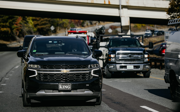 SUV and other cars driving on a road