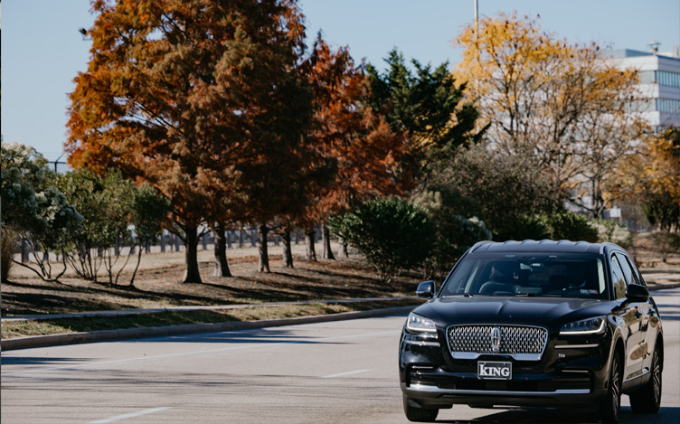 Car driving on a road in the fall