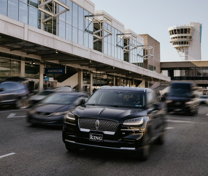 cars driving by the airport